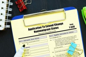clipboard with form i-539 application to extend change nonimmigrant status