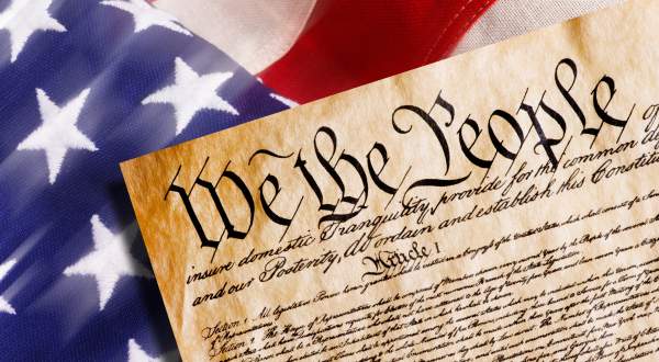 Preamble of the U.S. Constitution and an American flag