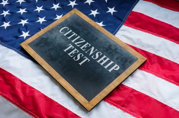 chalkboard displaying the words citizenship test on american flag