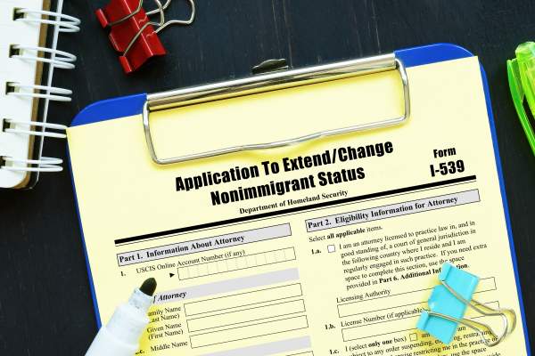 clipboard with form i-539 application to extend change nonimmigrant status