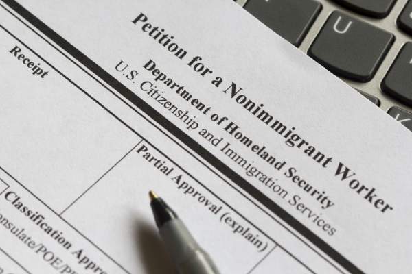 close-up of pen and uscis form 129 petition for nonimmigrant worker