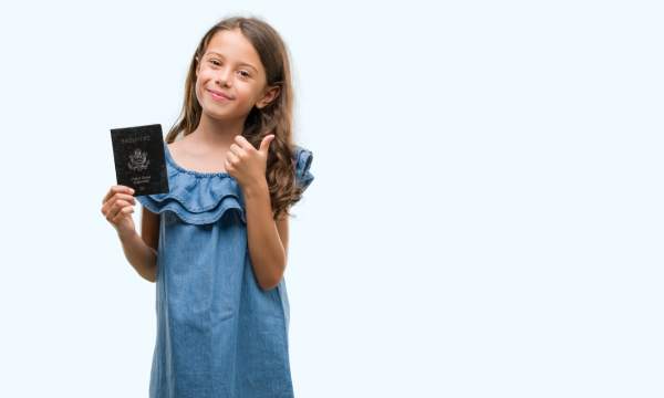 girl holds up her us passport