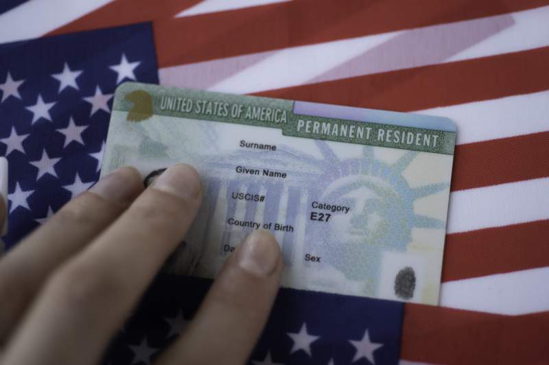 green card in front of the american flag