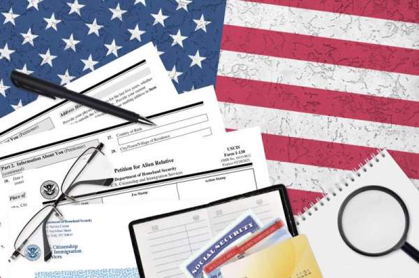pen and various documents including petition for alien relative spread out over american flag