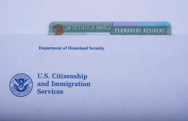 permanent resident card behind uscis letterhead