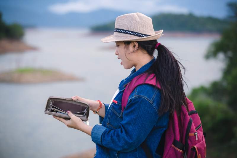 woman searching her wallet for green card