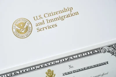 USCIS letterhead with a certificate of naturalization.